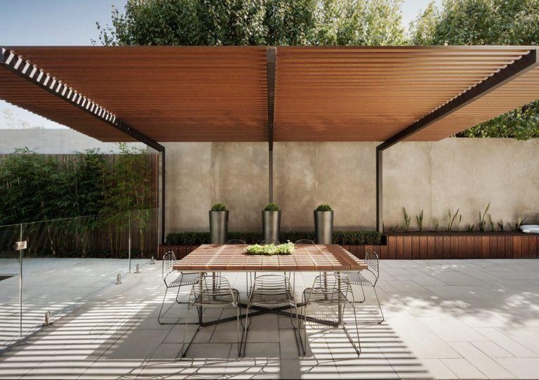 Luxury composite pergola installed over a modern outdoor dining and entertainment area in South Africa.