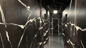 Bespoke liquid wallpaper design across an interior corridor by Nomad Gallery